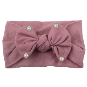 Close-up of baby nylon headband with dusty rose bow and delicate white pearl accents