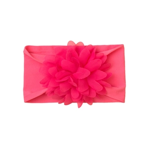 Detailed view of hot pink baby headband with large layered 3D fabric flower decoration