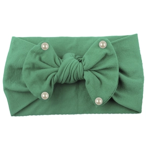 Detail of dark green nylon baby headband with soft knit texture and pearl bow accents