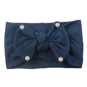 Detail of navy blue nylon baby headband with a large soft bow and white pearl accents