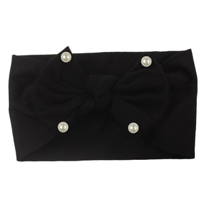 Detail view of soft black nylon baby headband with a large bow and four white pearls