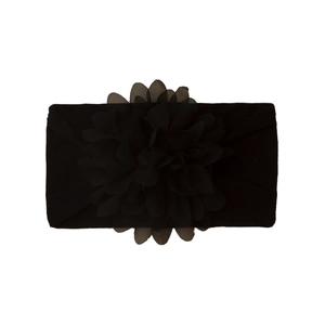 Detailed view of a wide black elastic nylon headband with a large chiffon flower