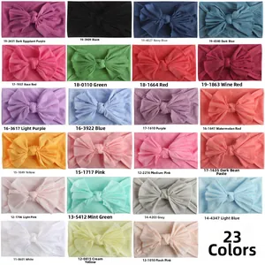 Detailed grid view showcasing 23 vibrant color variants of soft nylon baby headbands with bows