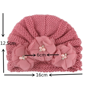 Pink knit baby turban featuring three 3D chiffon flowers with pearls and rhinestones