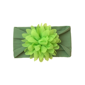 Detailed top view of light green chiffon flower on wide nylon baby headband