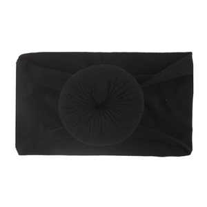 Détail d'un bandeau noir doux en nylon pour bébé avec un nœud en forme de donut