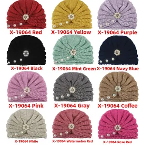 Detail view of 12 color options for kids knitted beanie with pearls and rhinestone flower