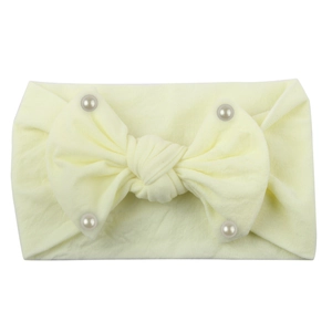 Soft cream yellow nylon baby headband featuring a large bow decorated with faux pearls