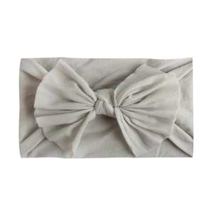 Soft light grey nylon headband for infants with a large ribbed texture bow detail