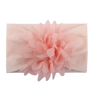 Soft light pink nylon baby headband featuring a large layered chiffon flower ornament