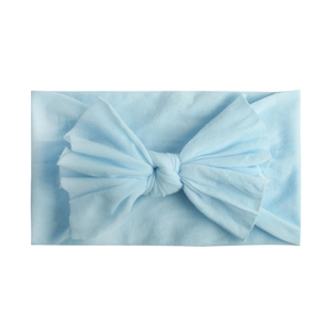 Detail of soft nylon light blue baby headband with large elastic knotted bow
