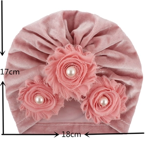 Pink velvet baby turban hat with three fabric flowers and white faux pearl details