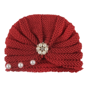Detailed knit texture of red infant turban hat with pearl and rhinestone flower
