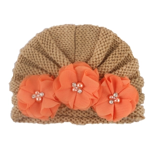 Camel knit baby turban hat featuring three large orange chiffon flowers with pearls