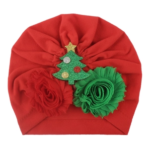 Christmas themed red baby turban hat with green tree and floral accents on white background