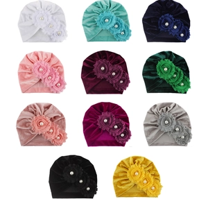Velvet baby turban hats with 3-flower pearl accents in 11 colors on white background