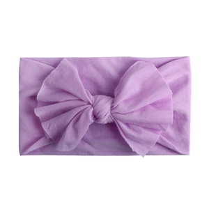 Close-up of soft lavender nylon baby headband with a large elastic knotted bow