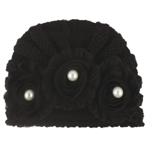 Detailed view of black knitted baby hat with handmade fabric flowers and white pearls