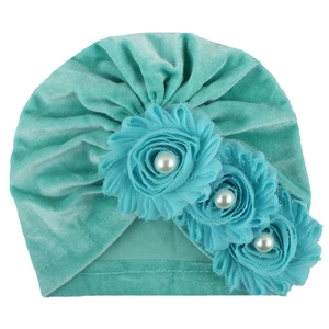 Teal green velvet baby turban hat with three fabric flowers and white pearl accents