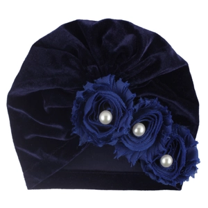 Detail of baby velvet turban with navy blue fabric roses and white faux pearl accents