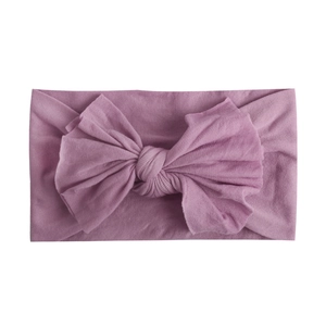 Close-up of soft lavender nylon baby headband with a large handmade bow detail