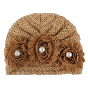 Close-up of khaki knit baby turban hat with three 3D flowers and pearl beads center