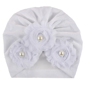 Soft white velvet baby turban hat with three floral accents and center pearls