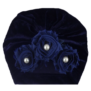 Detail of dark blue velvet baby turban hat with decorative fabric roses and white pearls