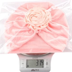 Bonnet turban rose pour bébé en velours avec grande fleur de rose pesant 31,4g sur la balance