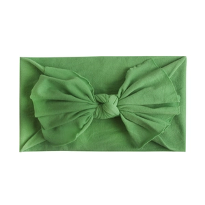 Detailed view of grass green baby headband with a large handmade soft bow knot