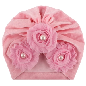 Pink velvet baby turban hat with three layered fabric flowers and faux pearls