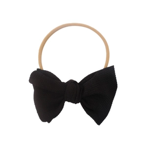Elastic nylon headband for infants featuring a large black bow ornament for baby girls