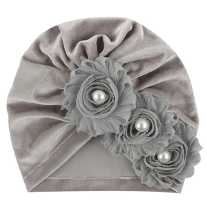 Detailed macro of silver grey velvet baby turban hat with decorative fabric roses and pearls