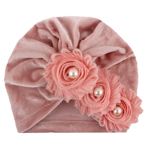 Pink velvet baby turban hat featuring three fabric roses with white faux pearls