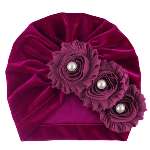 Detail of soft purple velvet baby turban with three handmade fabric roses and white pearls