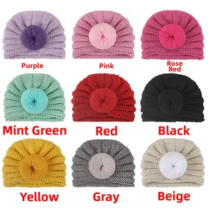 Detail showing nine colors of newborn knit donut hats including pink, mint and gray