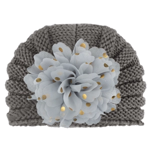 Detail of baby knit turban hat in grey with large gold polka dot mesh flower ornament