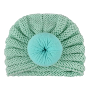 Detail view of mint green knit baby turban hat with a soft donut knot decoration