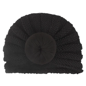 Detailed view of black knitted turban hat with 3D donut knot and fine stitch pattern