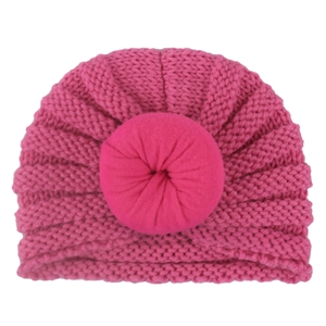 Detail of rose red baby knit turban hat featuring a soft doughnut knot and ribbed texture