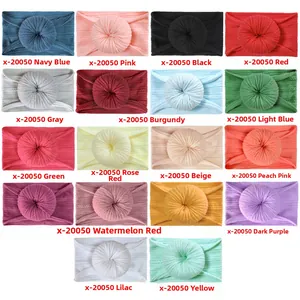 Grid view of 18 colorful donut-style soft nylon headbands for babies and infants