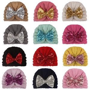 Collection of baby turban hats in 12 colors with large sparkly sequin bow details