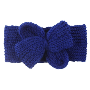 Gros plan d'un bandeau en tricot bleu foncé avec un grand nœud pour l'hiver