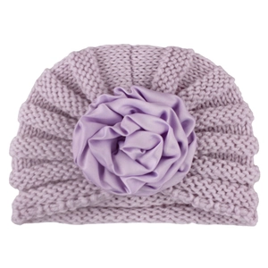 Close-up of baby knit hat with soft satin flower detail and premium woven texture