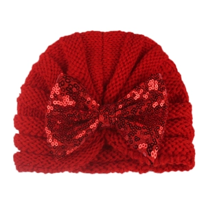 Red knit baby beanie hat with a large sequined bow for autumn and winter warmth