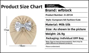 Detail of infant beige turban hat showing milk silk material and 26.9g weight specs