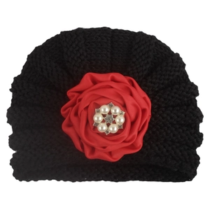 Bonnet bébé en tricot noir orné d'une grande fleur en satin rouge et de perles