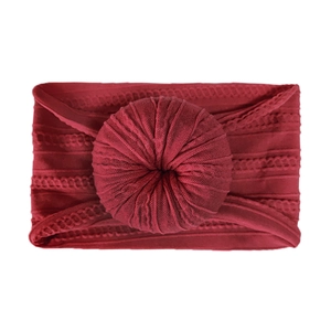 Close-up of baby nylon headband featuring wine red donut knot and ribbed jacquard texture