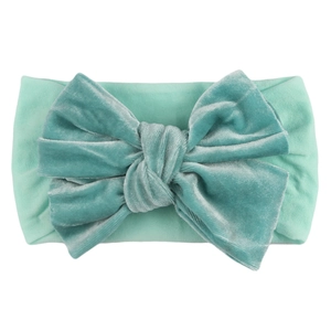 Elastic mint green baby headband featuring a large velvet bow for infant hair accessories