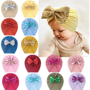 Detailed grid of baby turban hats with sequin bows in fourteen vibrant color options